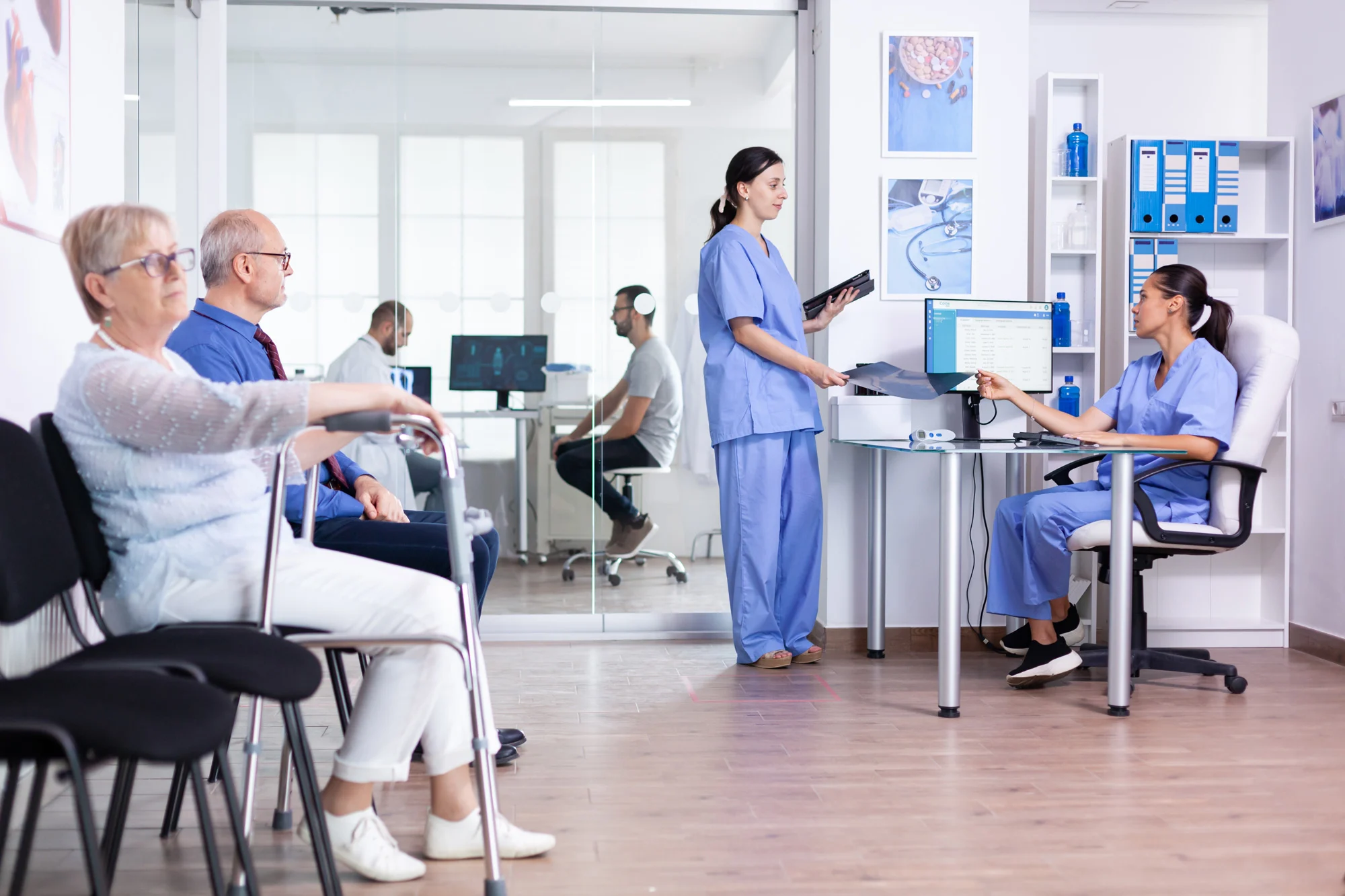 Hospital reception and waiting area with healthcare staff managing patient care and clinic safety via Disrupt-X HSEQ