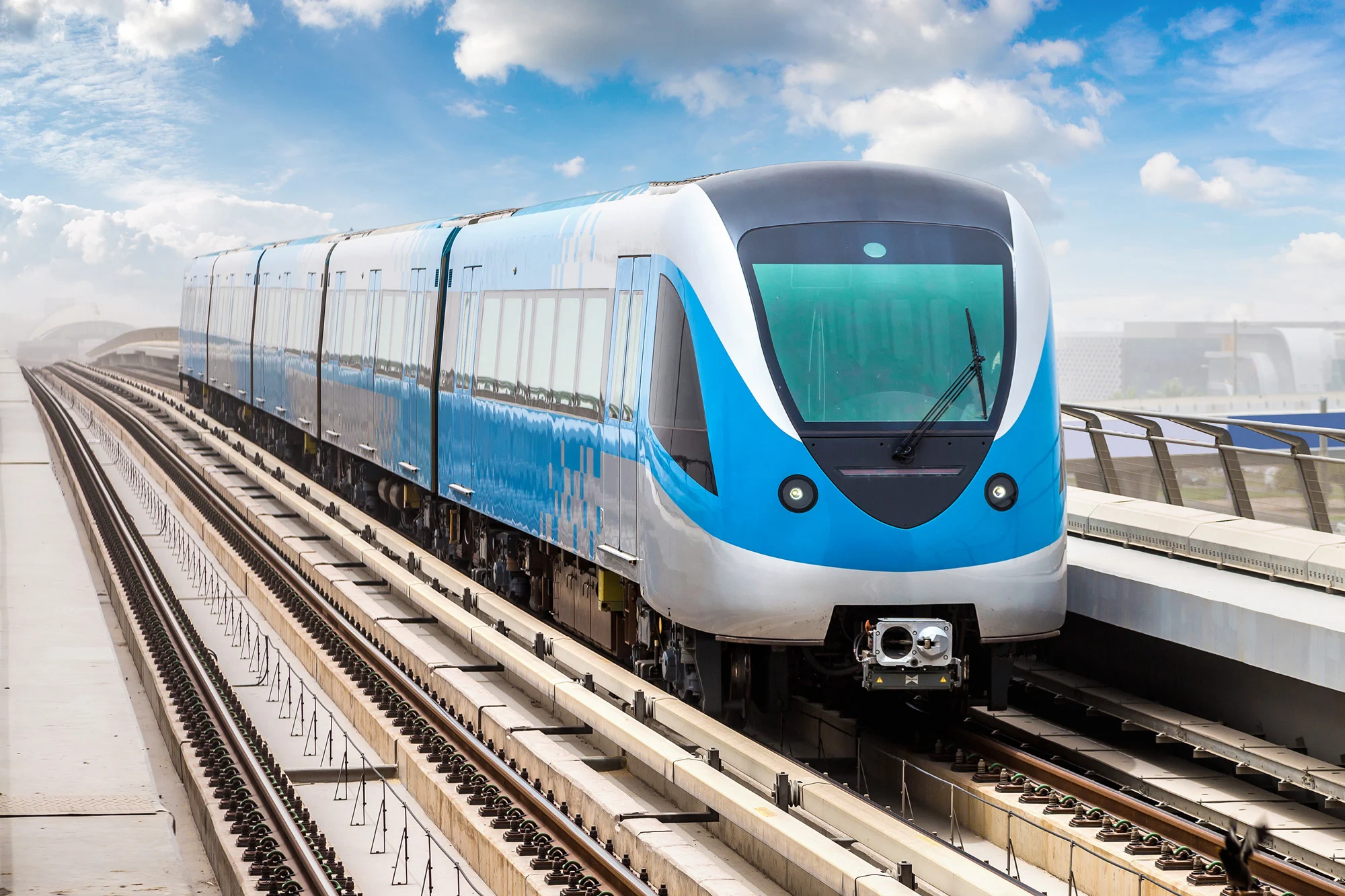 Modern automated metro train on elevated railway track representing transit passenger safety under Disrupt-X HSEQ