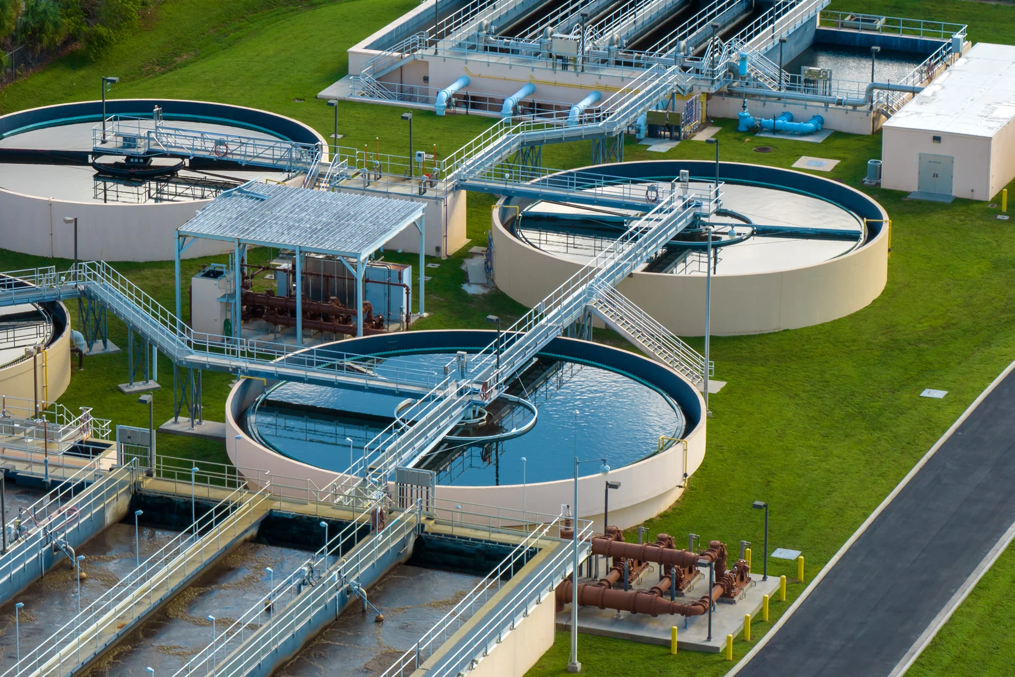 Aerial view of wastewater treatment clarifier tanks operating under Disrupt-X HSEQ environmental compliance